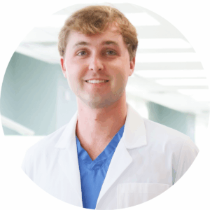 a male dentist in a white coat
