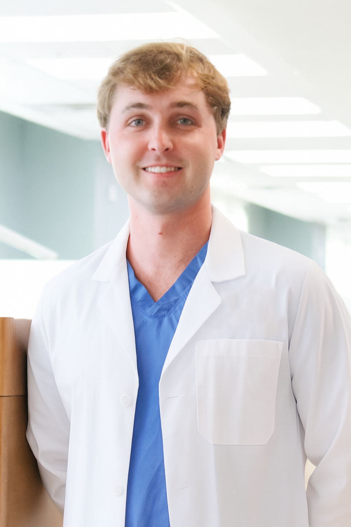 a male dentist in a white lab coat
